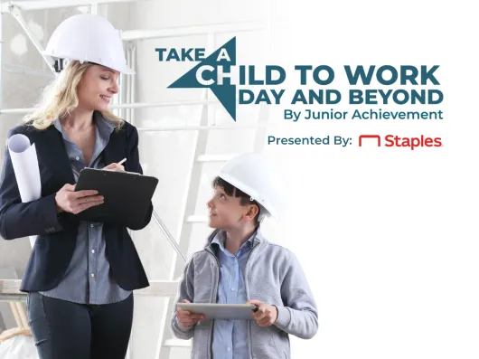 A woman and a boy in hardhats touring a construction site